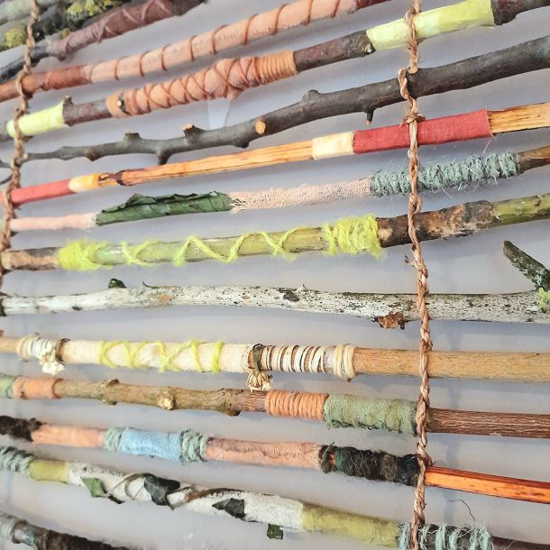 'Hedgerow Weave', inspired by the tangle and colours of hedgerows, twigs and hand twined plant fibres weave together to make a beautiful weave of complimentary colours - deep reds and browns with fresh vibrant green.